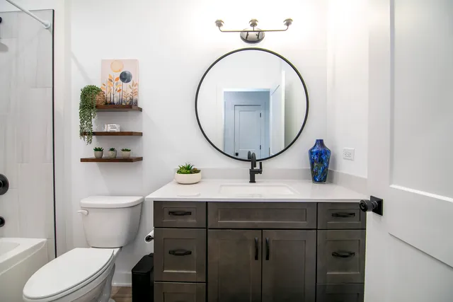 a bathroom with a toilet a sink and a mirror