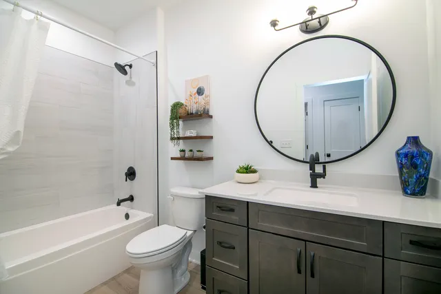 a bathroom with a toilet a sink and a mirror