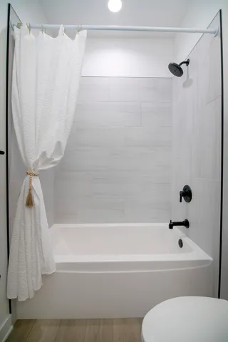 a bathroom with a bathtub and a shower