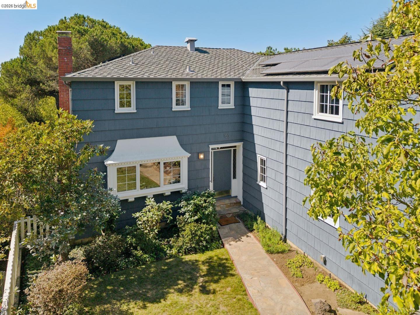 155 Avenida Drive Berkeley, CA 94708 - Photo 80 of 86 Shingle-sided exterior with a white-trimmed bay window and a stone pathway