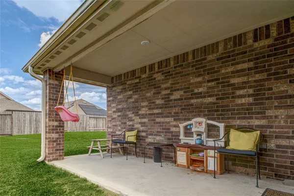 a brick building with a bench in front of it