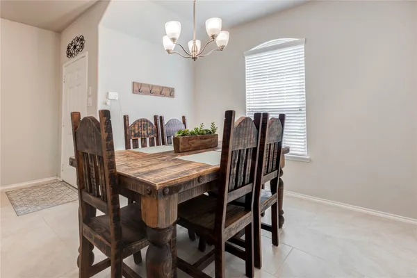 a view of a dining room with furniture and chandelier