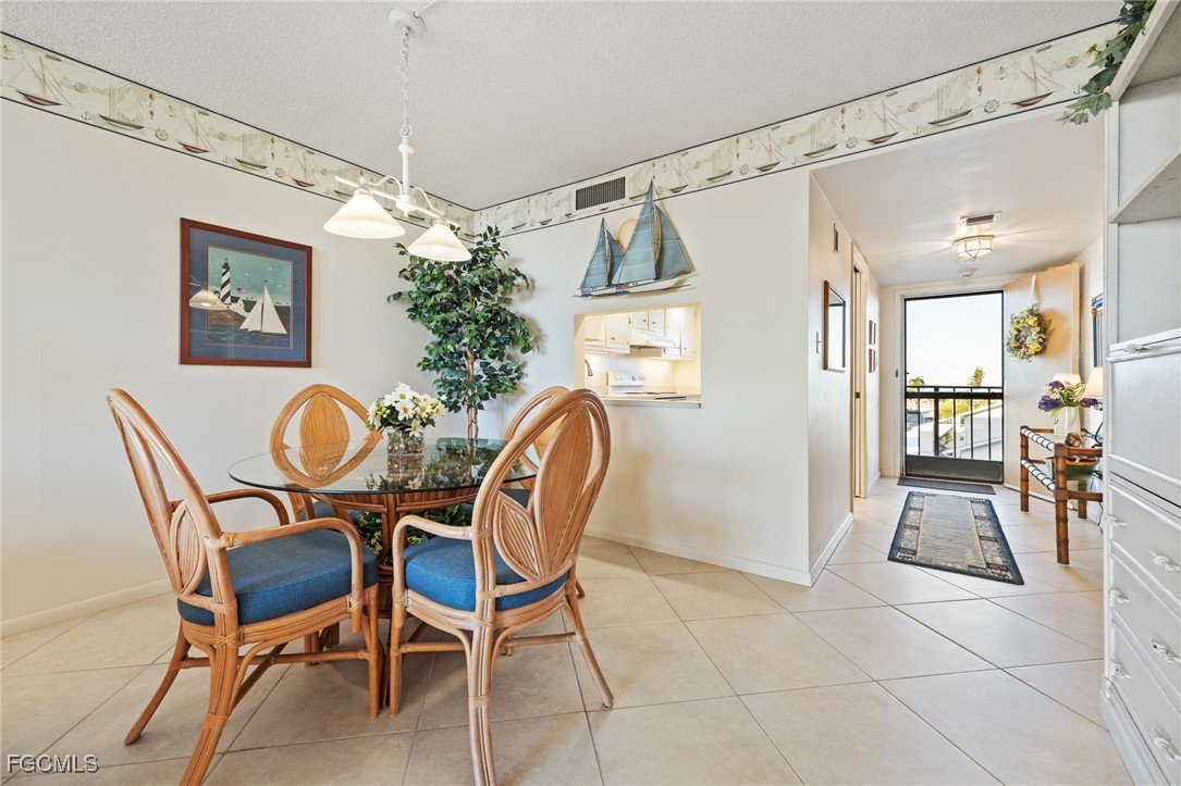 4260 Southeast 20th Place, Unit 502 Cape Coral, FL 33904 - Photo 14 of 49 a dining room with furniture and window