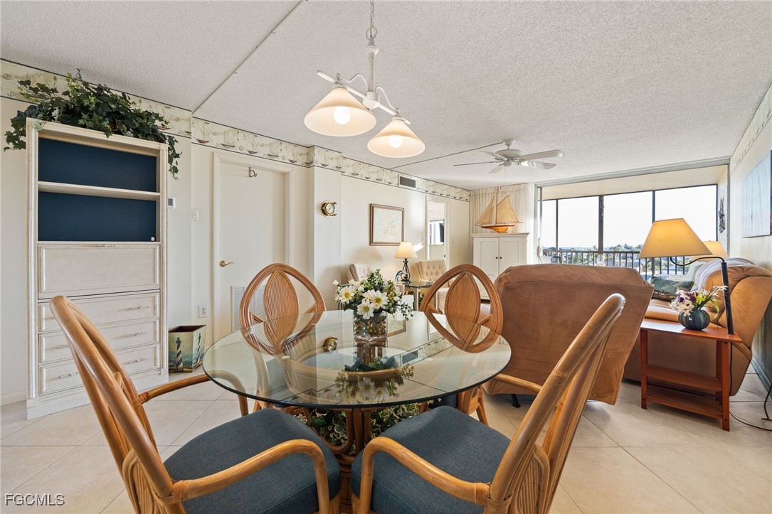 4260 Southeast 20th Place, Unit 502 Cape Coral, FL 33904 - Photo 15 of 49 a view of a dining room with furniture and chandelier