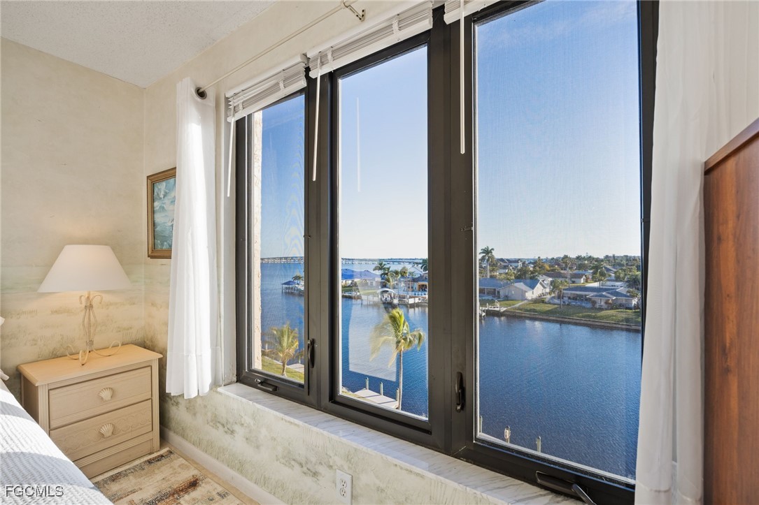 4260 Southeast 20th Place, Unit 502 Cape Coral, FL 33904 - Photo 18 of 49 a view of a walk in closet and bedroom from a window