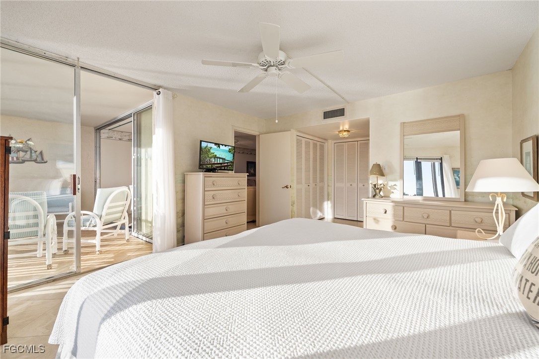 4260 Southeast 20th Place, Unit 502 Cape Coral, FL 33904 - Photo 22 of 49 a bedroom with a bed and a chandelier