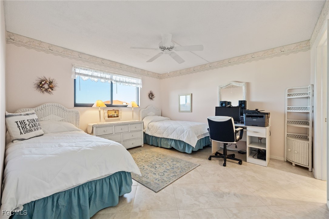 4260 Southeast 20th Place, Unit 502 Cape Coral, FL 33904 - Photo 24 of 49 a bedroom with a bed and a table chair