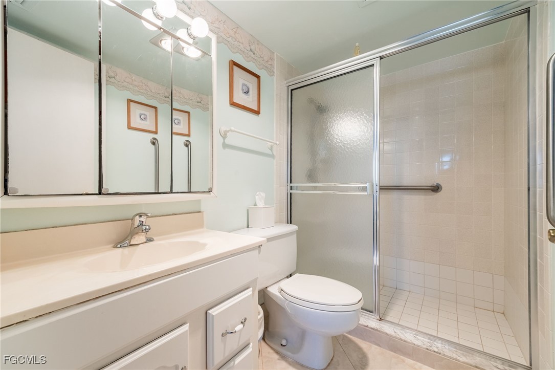 4260 Southeast 20th Place, Unit 502 Cape Coral, FL 33904 - Photo 26 of 49 a bathroom with a sink a toilet and shower