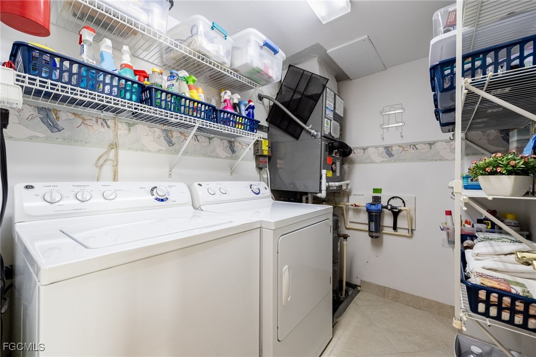 4260 Southeast 20th Place, Unit 502 Cape Coral, FL 33904 - Photo 27 of 49 a utility room with dryer and washer
