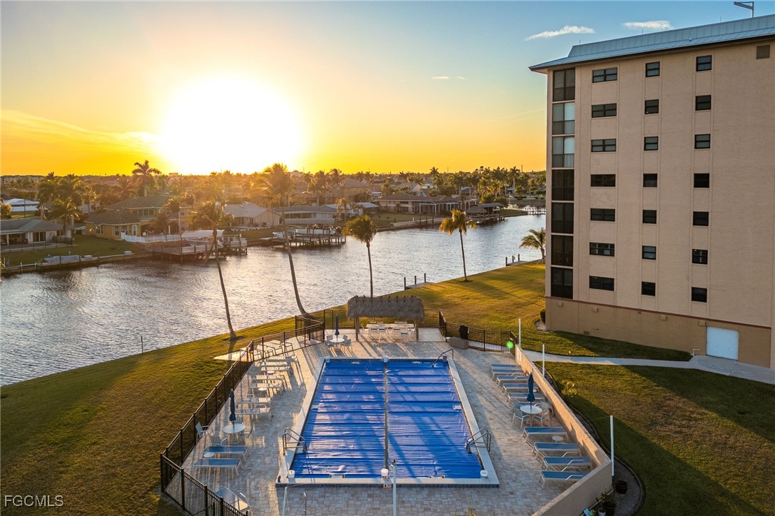 4260 Southeast 20th Place, Unit 502 Cape Coral, FL 33904 - Photo 3 of 49 a view of a swimming pool with a lake view