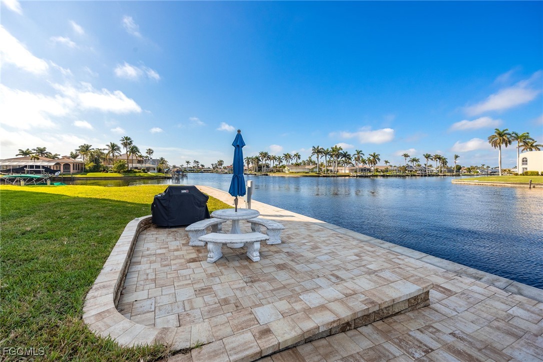 4260 Southeast 20th Place, Unit 502 Cape Coral, FL 33904 - Photo 32 of 49 a view of a lake with couches in the patio