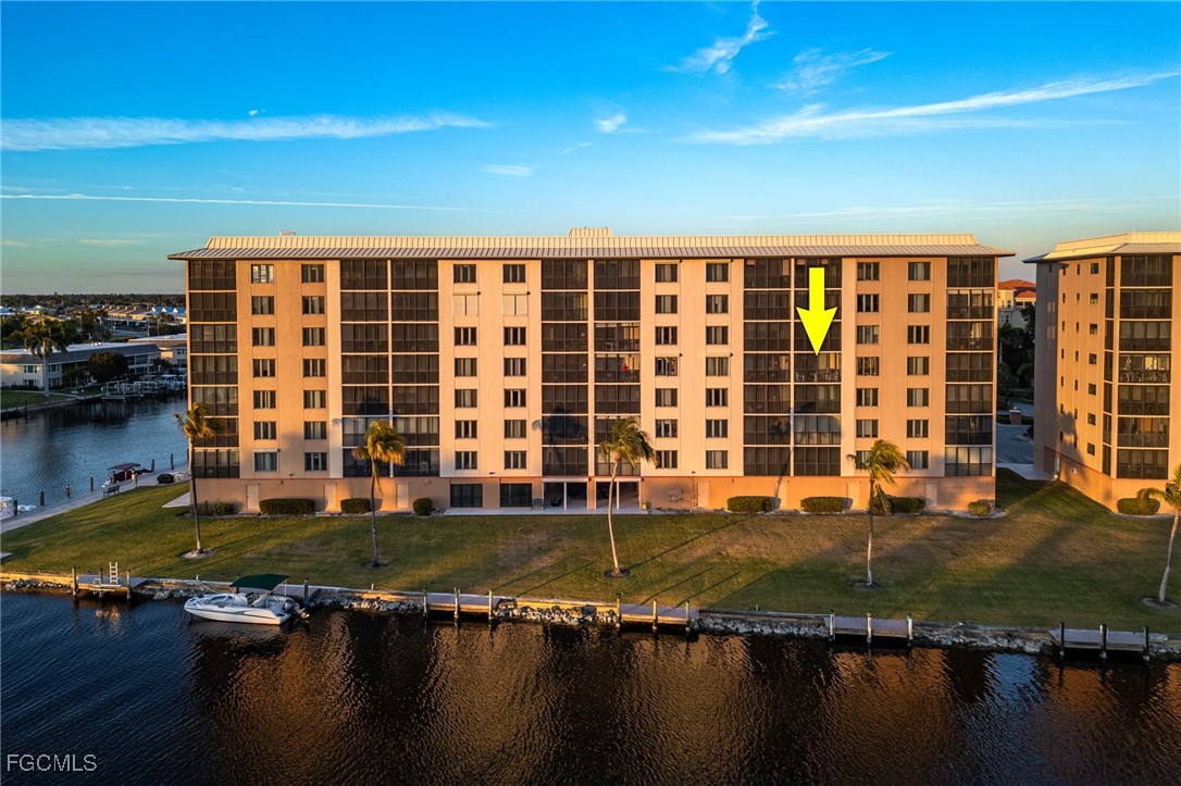 4260 Southeast 20th Place, Unit 502 Cape Coral, FL 33904 - Photo 41 of 49 a view of a house with pool in front of it