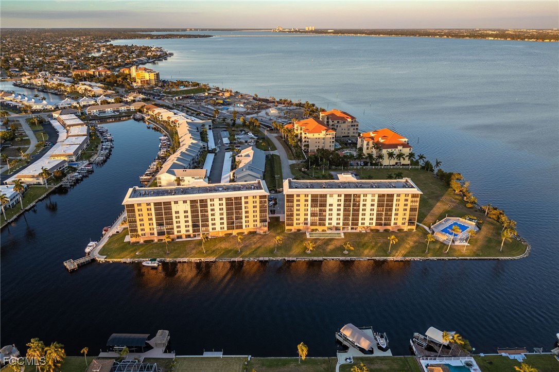 4260 Southeast 20th Place, Unit 502 Cape Coral, FL 33904 - Photo 42 of 49 an aerial view of house with yard swimming pool and outdoor seating