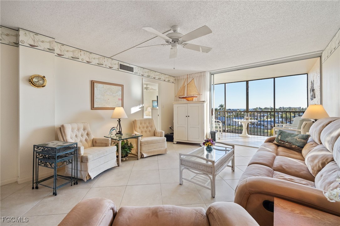 4260 Southeast 20th Place, Unit 502 Cape Coral, FL 33904 - Photo 5 of 49 a living room with furniture and a large window