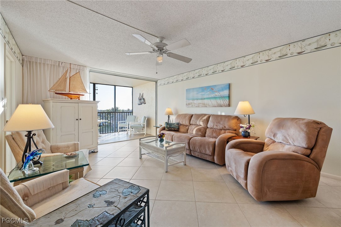 4260 Southeast 20th Place, Unit 502 Cape Coral, FL 33904 - Photo 6 of 49 a living room with furniture and a large window