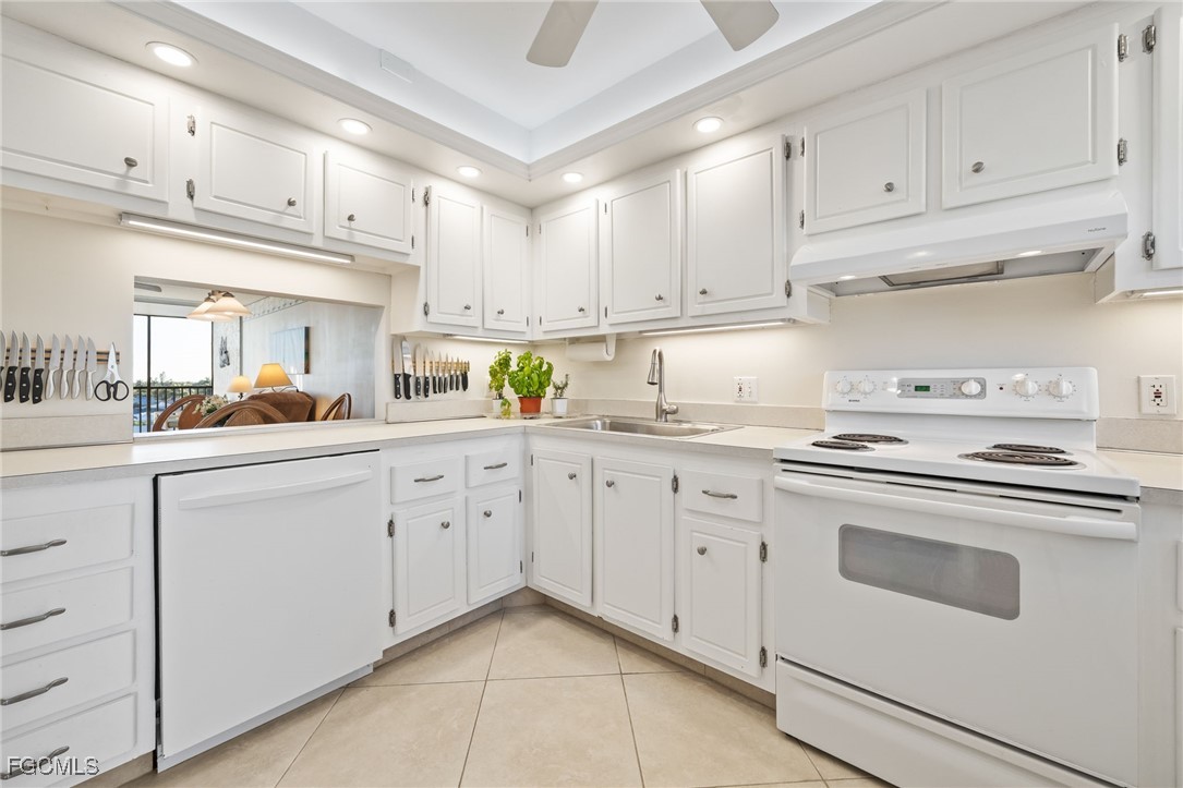 4260 Southeast 20th Place, Unit 502 Cape Coral, FL 33904 - Photo 9 of 49 a kitchen with granite countertop white cabinets and white appliances