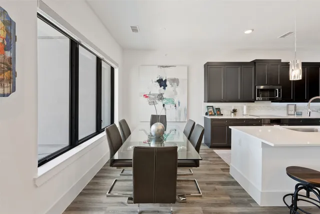 a dining room with furniture and a kitchen view