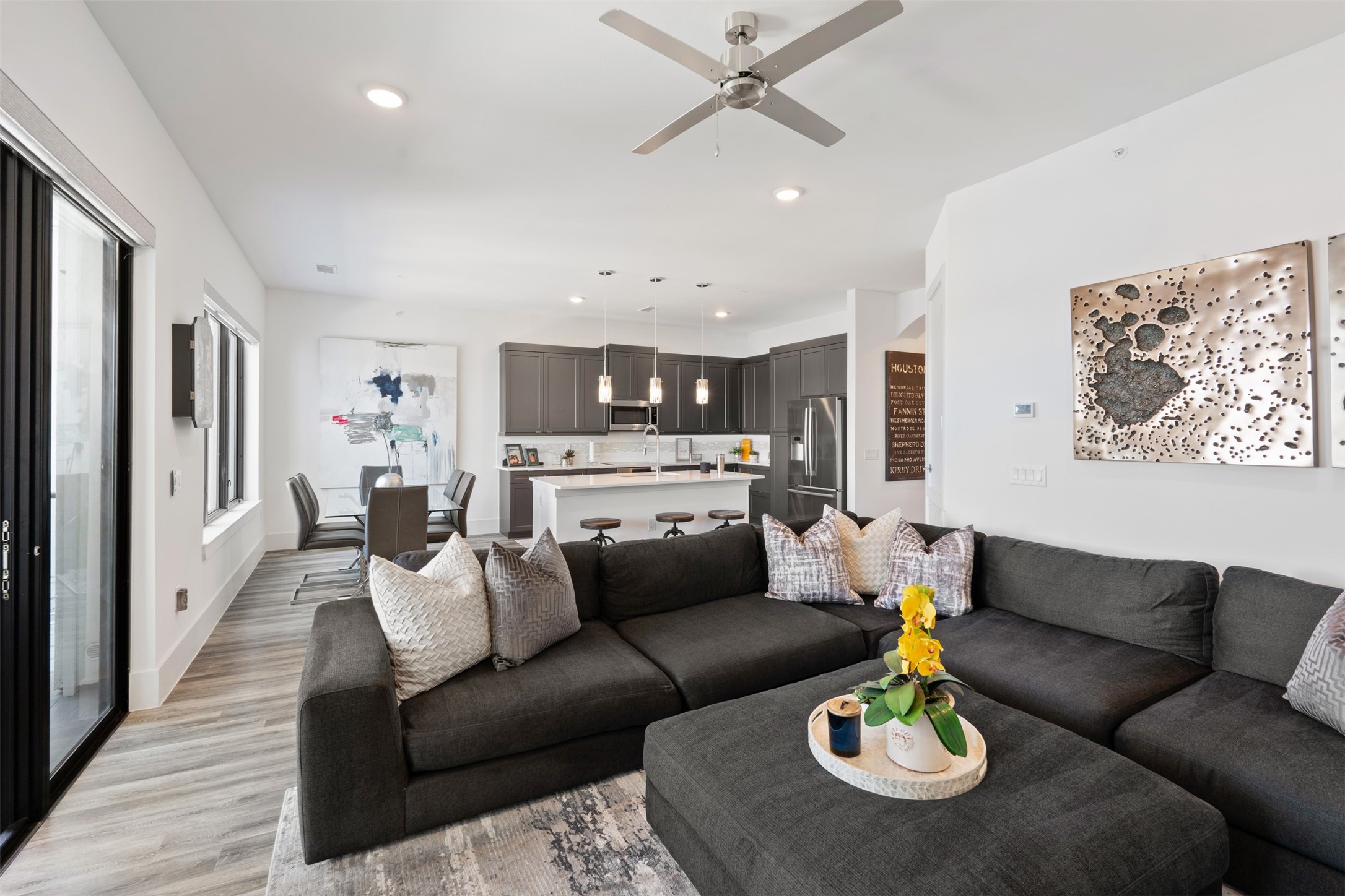 199 Waterpoint Court, Unit 208 Conroe, TX 77304 - Photo 21 of 39 a dining room with furniture kitchen view and a wooden floor