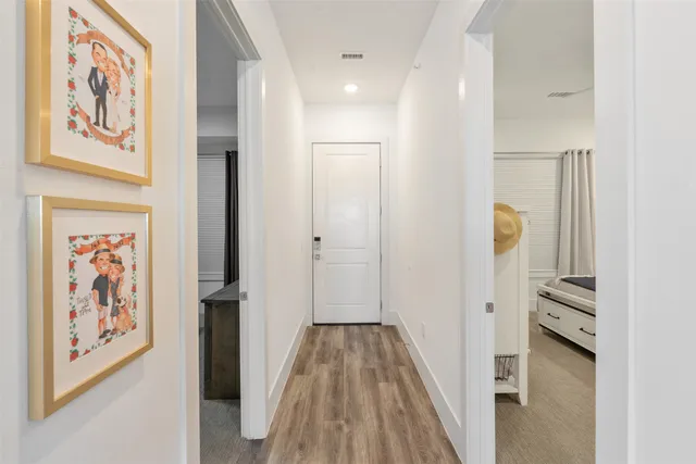 a view of hallway with wooden floor