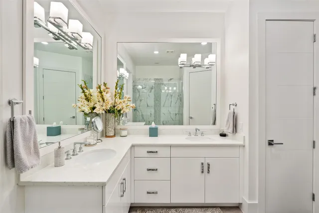 a bathroom with a sink double vanity and a mirror