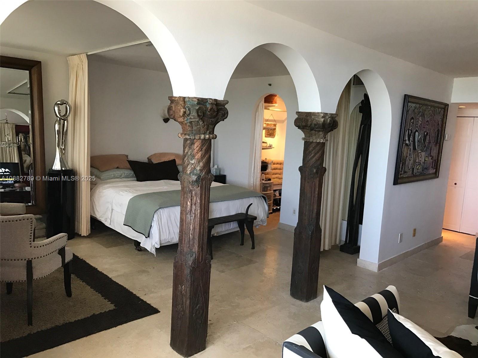 100 Lincoln Road, Unit 644 Miami Beach, FL 33139 - Photo 11 of 46 a bedroom with bed and a chandelier