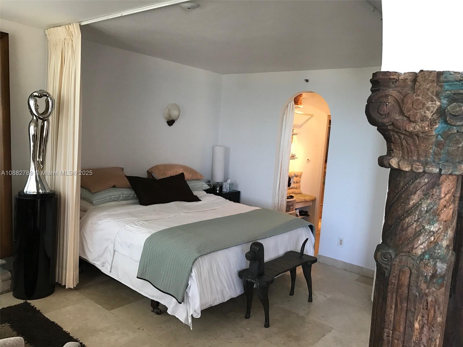 100 Lincoln Road, Unit 644 Miami Beach, FL 33139 - Photo 17 of 46 a bedroom with a bed and a chandelier