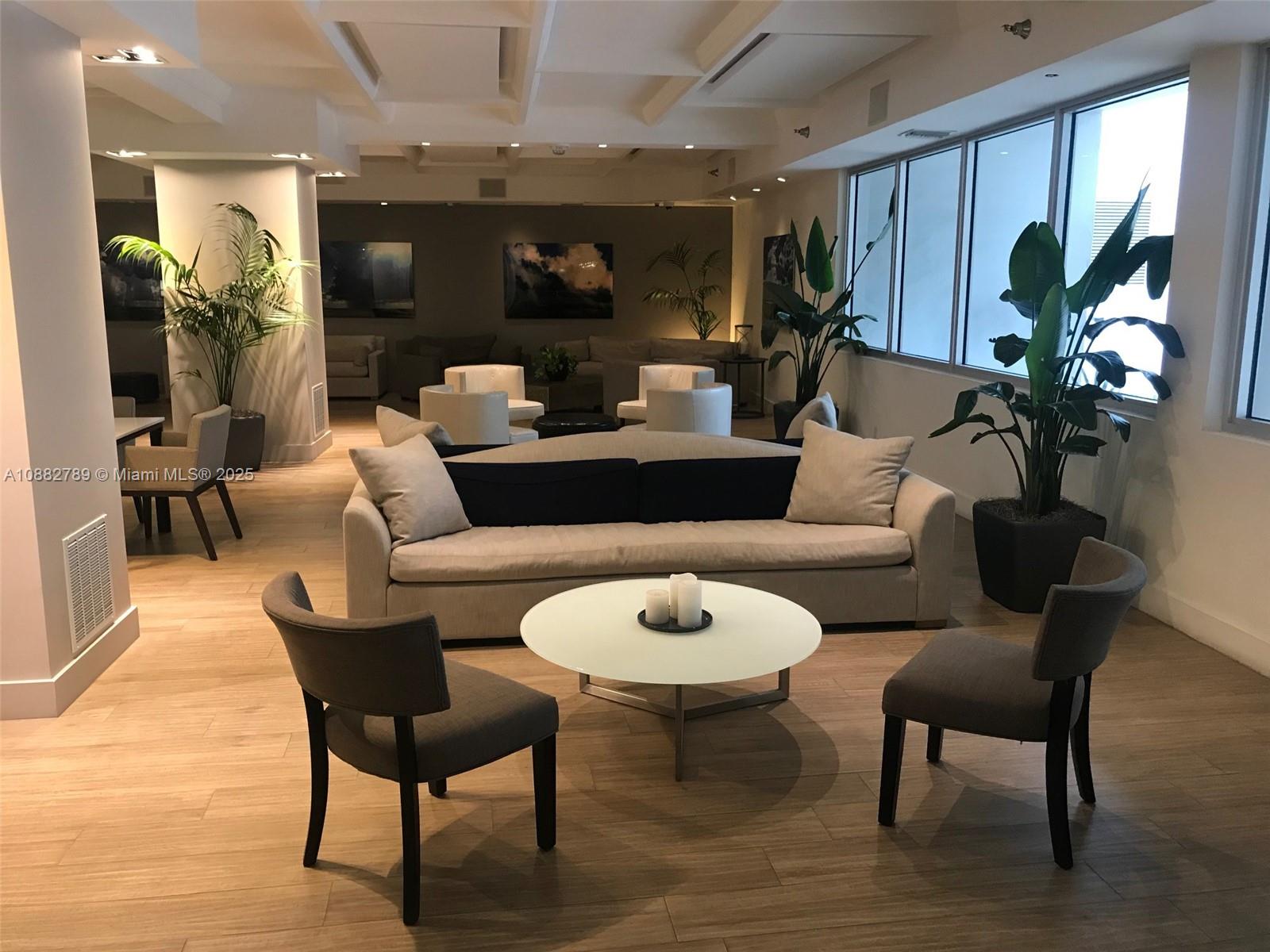 100 Lincoln Road, Unit 644 Miami Beach, FL 33139 - Photo 29 of 46 a living room with furniture potted plant and a wooden floor