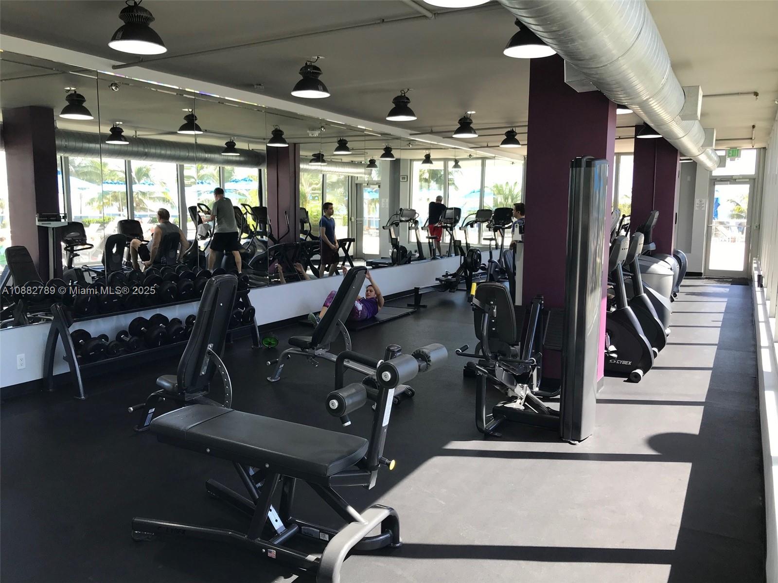 100 Lincoln Road, Unit 644 Miami Beach, FL 33139 - Photo 35 of 46 a room with gym equipment and large mirror