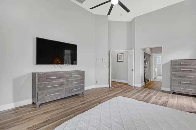 a view of room with wooden floor and flat screen tv