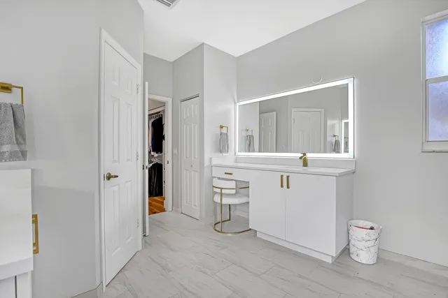 a room with a white cabinets and washer