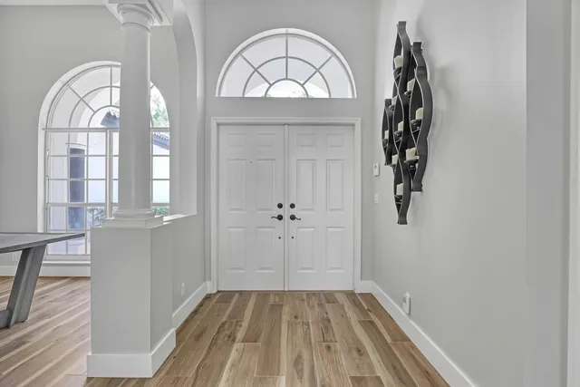 a view of a livingroom with wooden floor and window