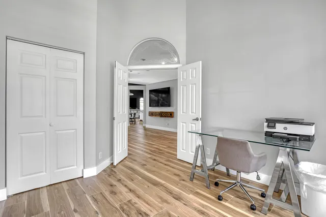a view of a livingroom with wooden floor and a ceiling fan