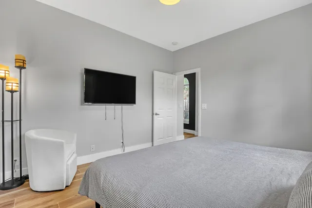 a bedroom with a bed and a flat screen tv