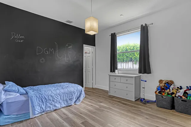 a bedroom with a bed and a chandelier