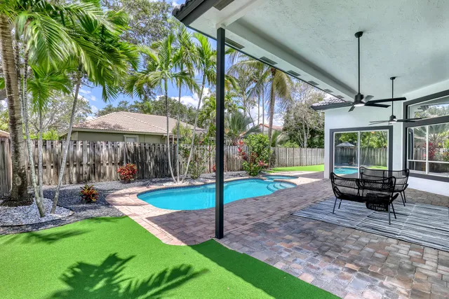 a view of a house with backyard and sitting area