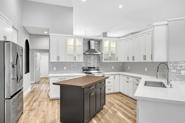 a kitchen with a sink stove and refrigerator