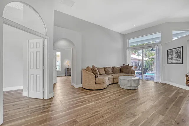 a living room with fireplace furniture and wooden floor