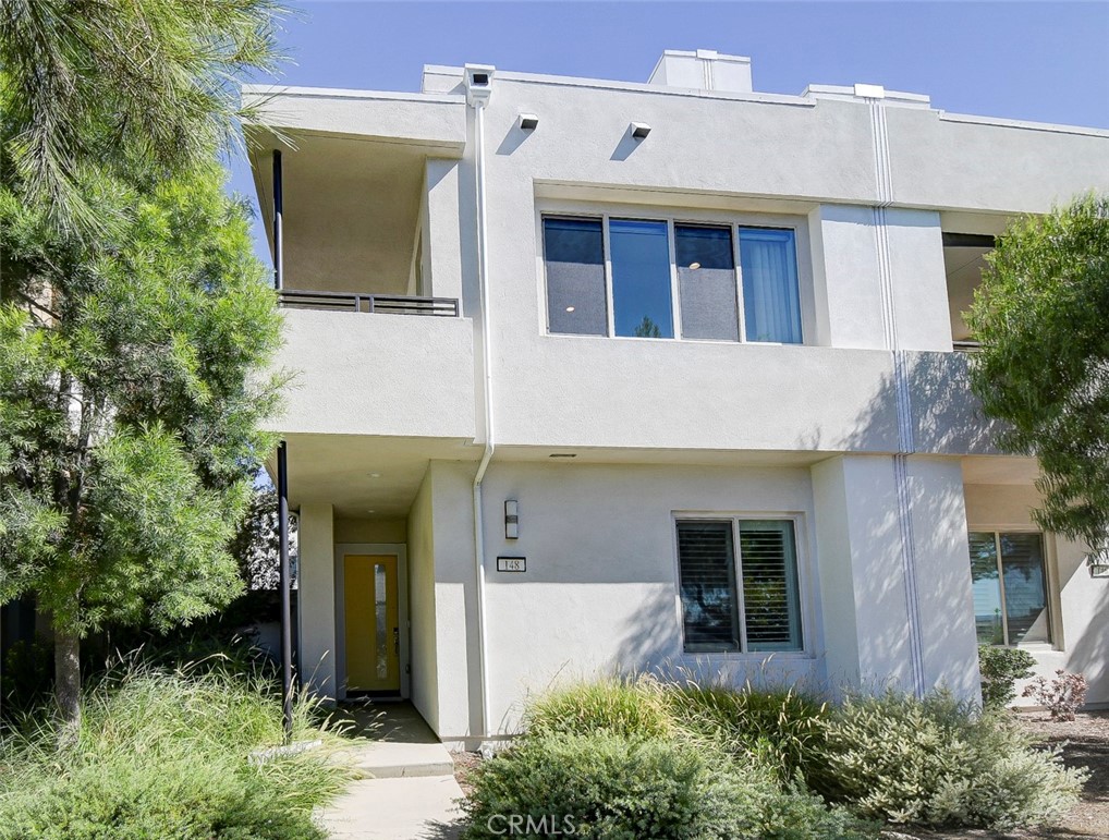 148 Spectacle Irvine, CA 92618 - Photo 1 of 47 a front view of a house with garden