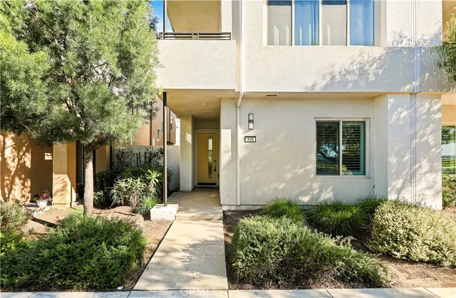 a large white room with kitchen view and a large window
