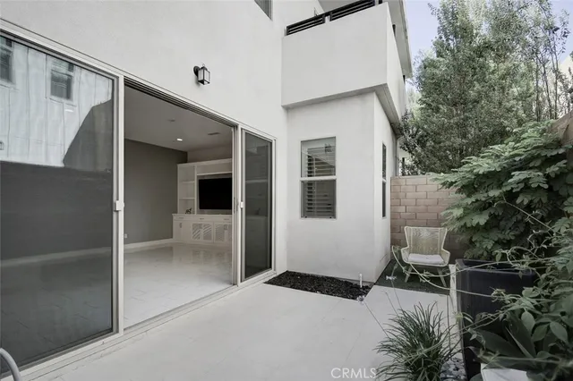 a balcony view with a potted plant and a window