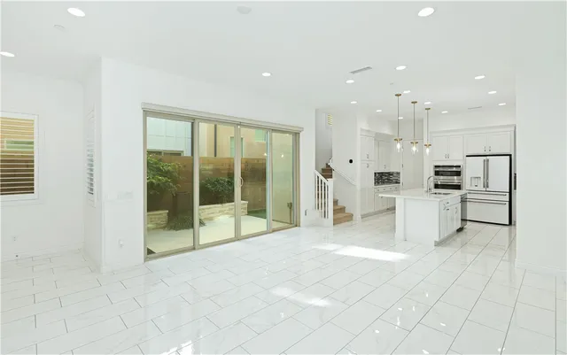 a large white room with a large mirror vanity and chandelier