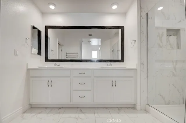a bathroom with a sink mirror and cabinets