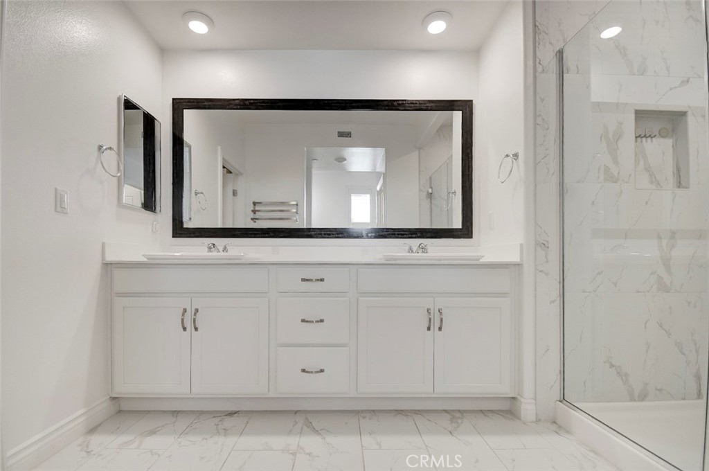 148 Spectacle Irvine, CA 92618 - Photo 23 of 47 a bathroom with a sink mirror and cabinets