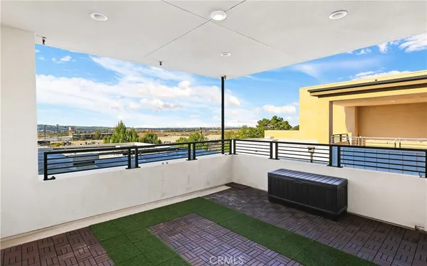 a view of a patio with a table under an umbrella