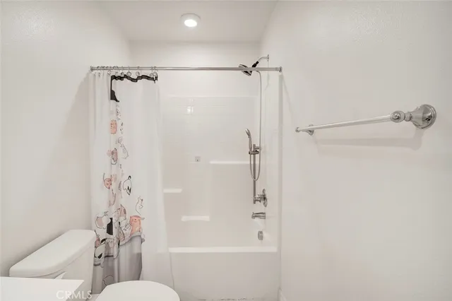 a bathroom with a shower a toilet and a shower