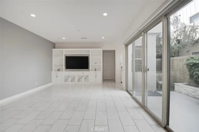 a view of a livingroom with an empty space and the hallway
