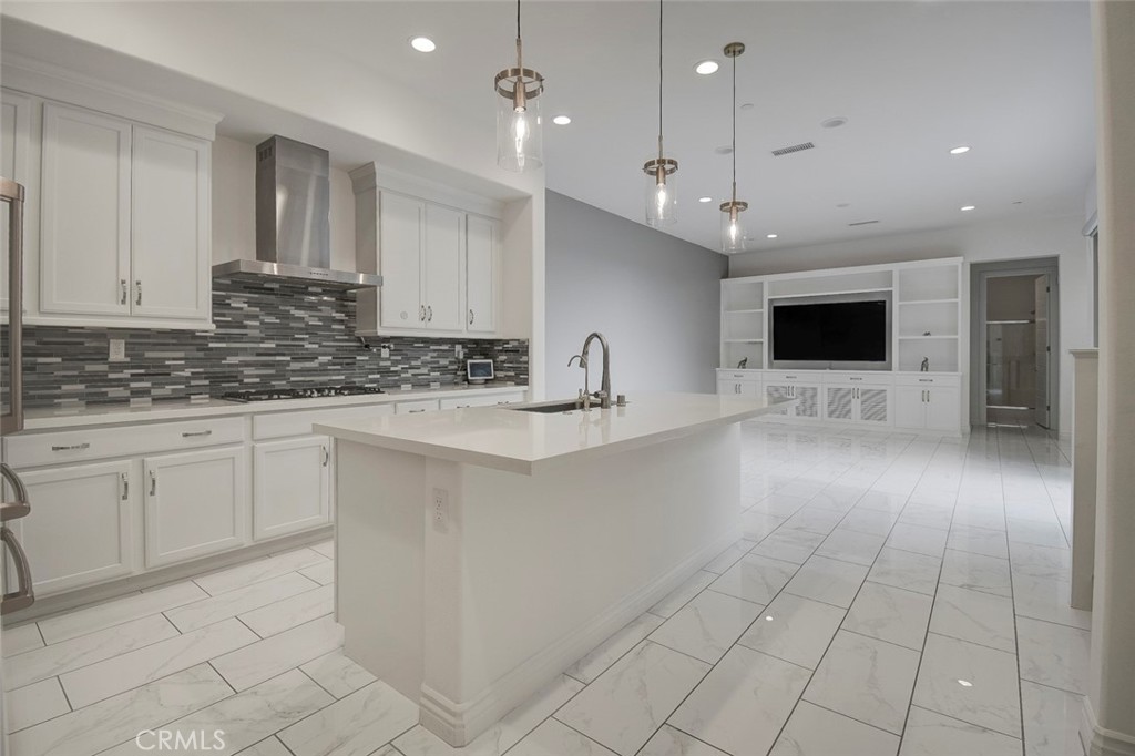 148 Spectacle Irvine, CA 92618 - Photo 5 of 47 a kitchen with stainless steel appliances granite countertop a sink a stove and cabinets