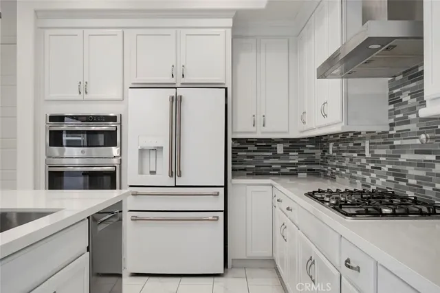 a kitchen with white cabinets and white appliances