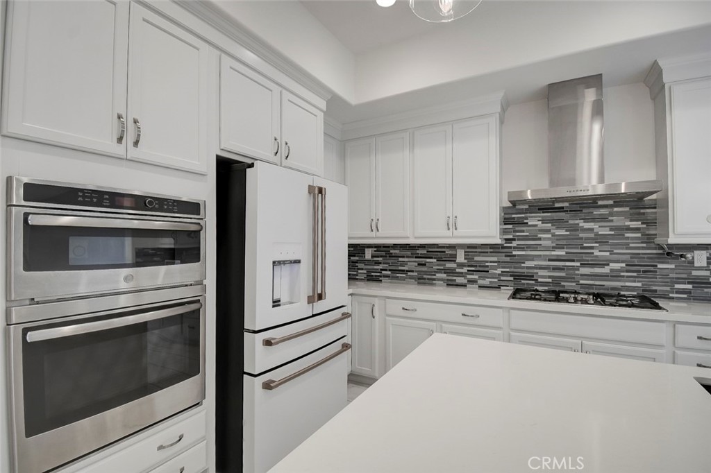 148 Spectacle Irvine, CA 92618 - Photo 9 of 47 a kitchen with granite countertop white cabinets and stainless steel appliances