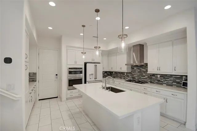 a kitchen with a sink a stove a refrigerator and cabinets
